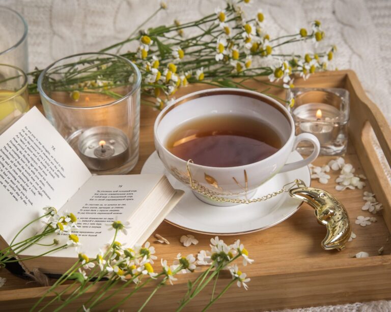 Chamomile tea, a book, and fresh chamomile