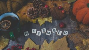 November on a witch's altar spelled out in scrabble pieces with seasonal decorations