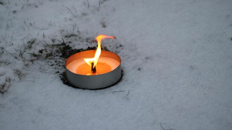 Imbolc ritual with a candle in the snow